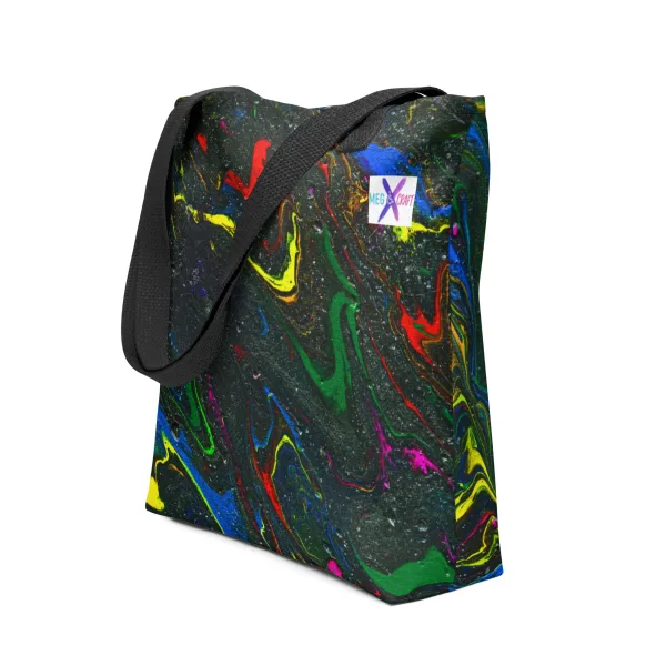 Tote bag with bright swirls of red, blue, and yellow mix with green representing the main characters on a glittering charcoal background to invoke the feel of space and black handles on a white backdrop.