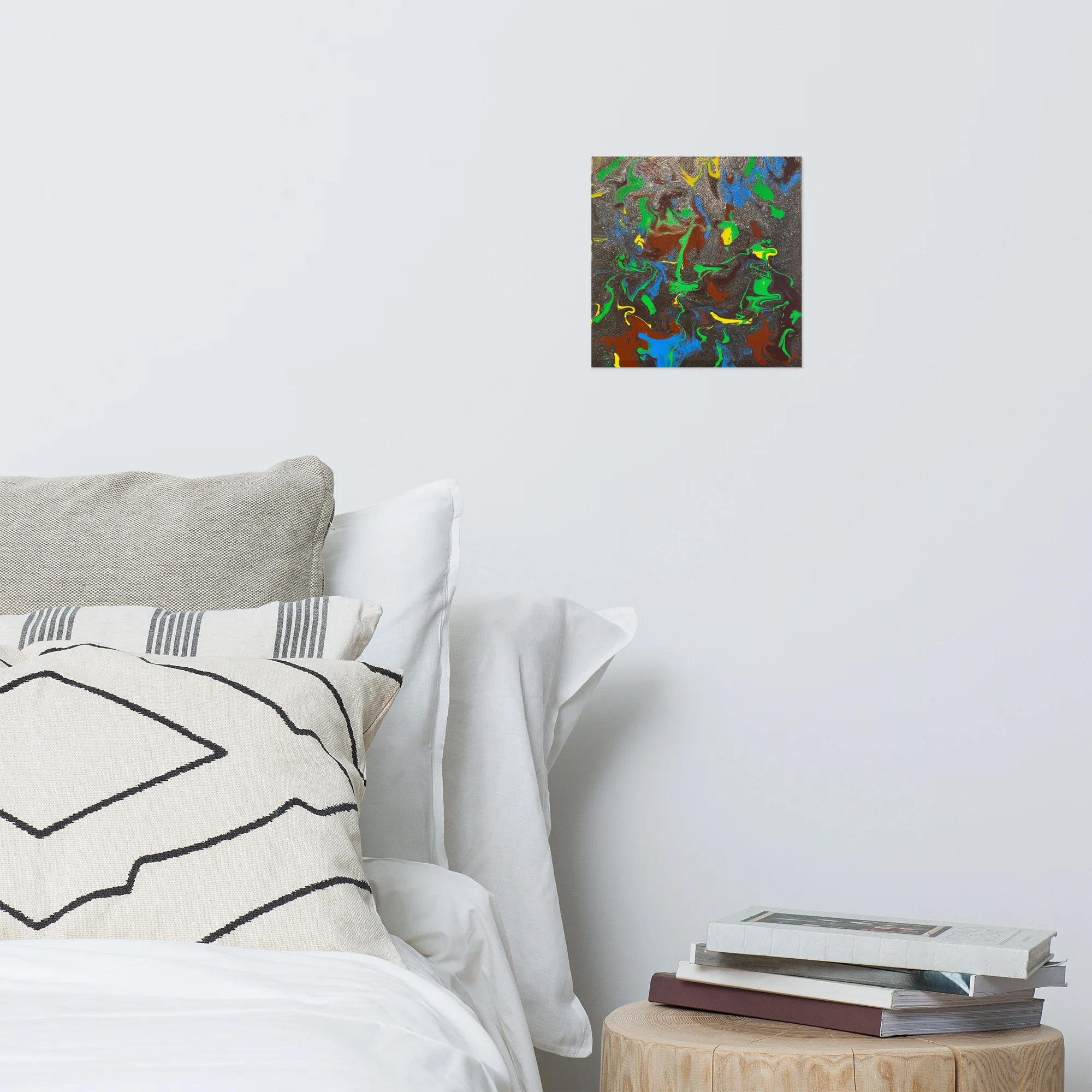 White bedroom wall with a print of The Force Is Strong, a piece that features swirling bright colors battling through the glittering black background.